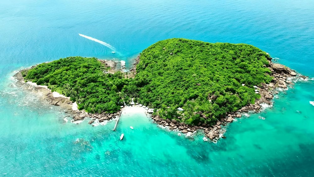 Thom Island Beach offers a peaceful escape with soft white sand, clear turquoise waters, and a tranquil tropical vibe perfect for sunbathing and swimming 